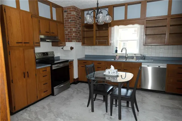 a kitchen with stainless steel appliances granite countertop a sink and cabinets