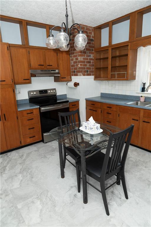 513 Lambertsville Road Stoystown, PA 15563 - Photo 17 of 49 a kitchen with a table chairs stove and cabinets