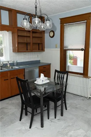 a dining room with a wooden table and chairs