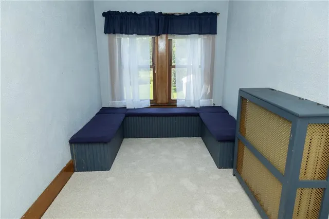 a bed sitting in a bedroom next to a window
