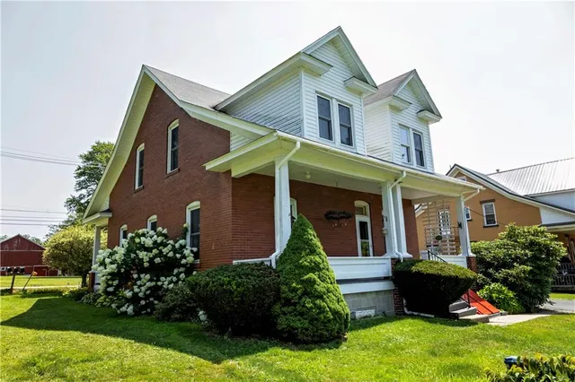 a view of backyard of house with green space