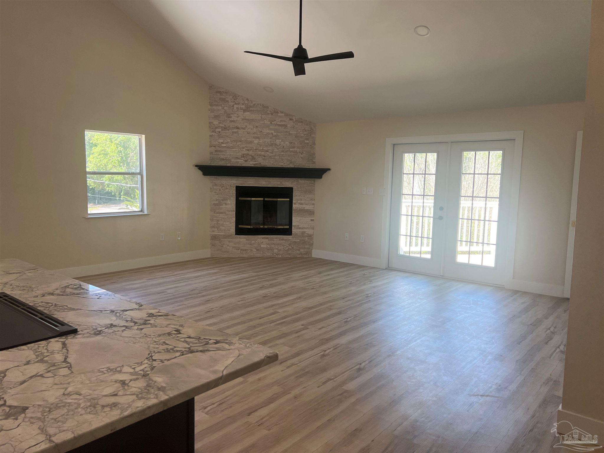 3111 Holley Point Road Navarre, FL 32566 - Photo 3 of 23 a view of empty room with wooden floor and fan
