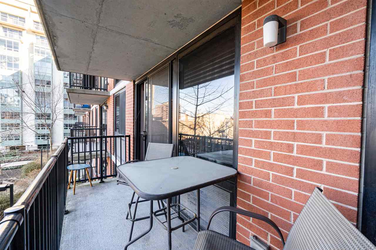 700 Grove Street, Unit 4V Jersey City, NJ 07310 - Photo 7 of 25 a view of a balcony with a table and chairs