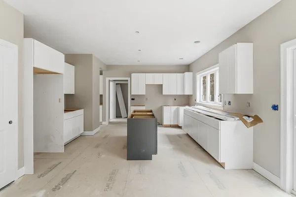 a kitchen with refrigerator and cabinets