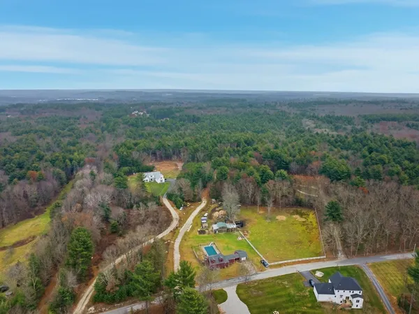 an aerial view of a house with a yard and lake view