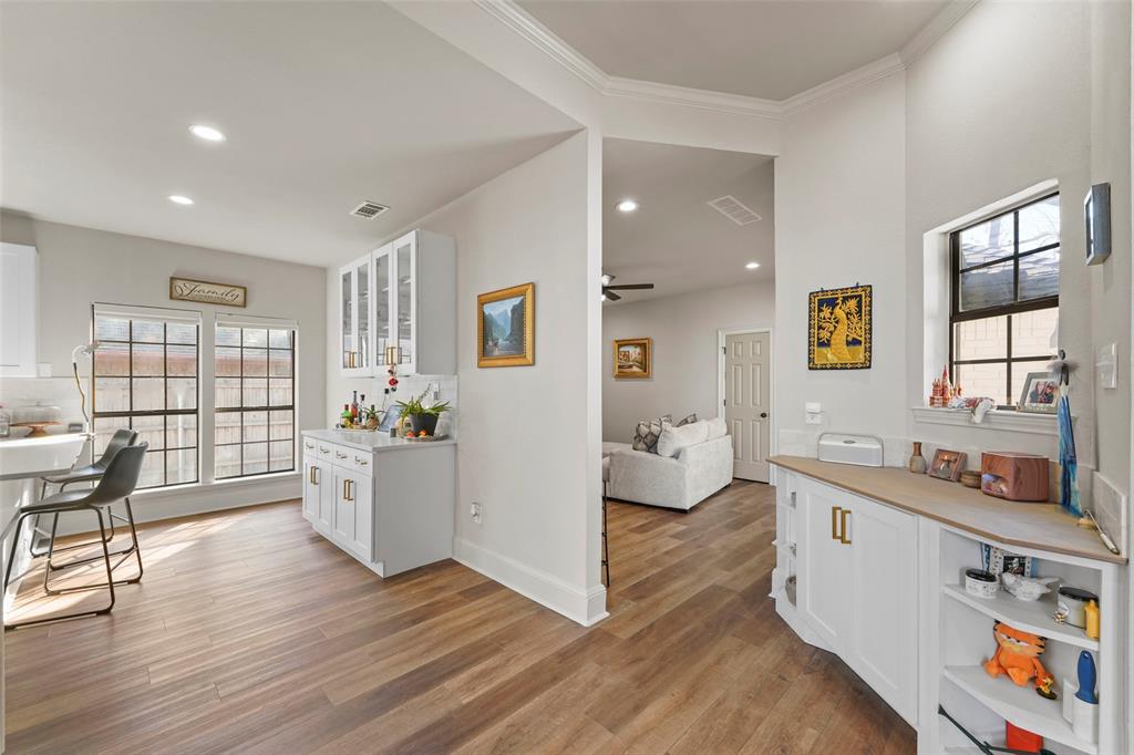 1413 Windsor Way Rowlett, TX 75088 - Photo 14 of 38 a large white kitchen with wooden floor and a sink