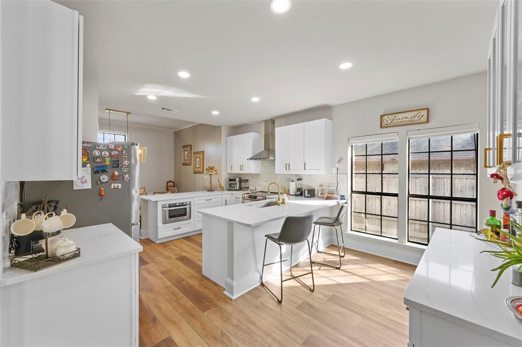 1413 Windsor Way Rowlett, TX 75088 - Photo 15 of 38 a kitchen with a sink cabinets and wooden floor