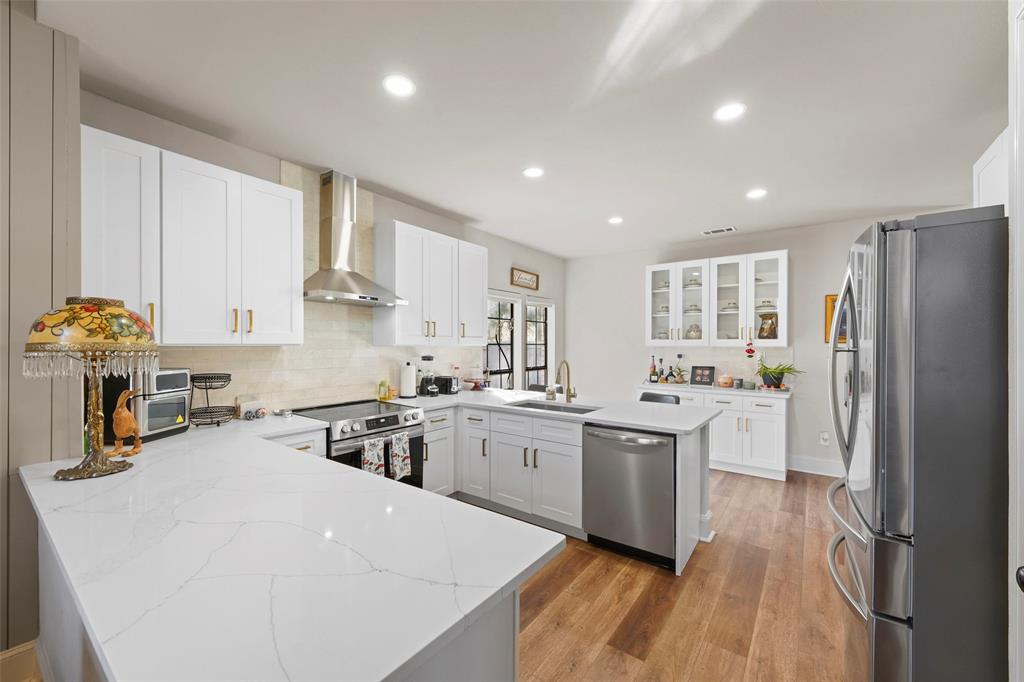 1413 Windsor Way Rowlett, TX 75088 - Photo 17 of 38 a kitchen with a sink a refrigerator and cabinets