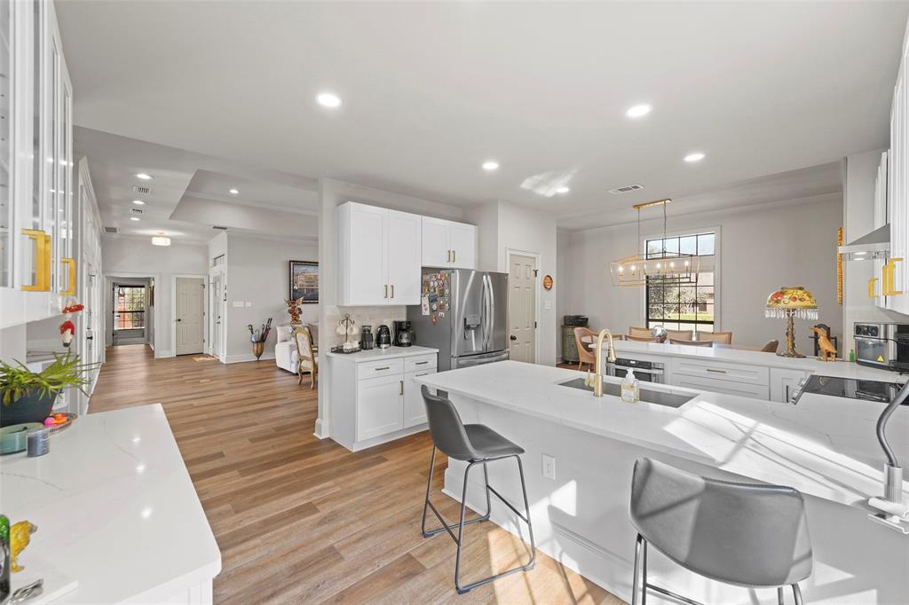 1413 Windsor Way Rowlett, TX 75088 - Photo 18 of 38 a kitchen with a dining table chairs stainless steel appliances and cabinets