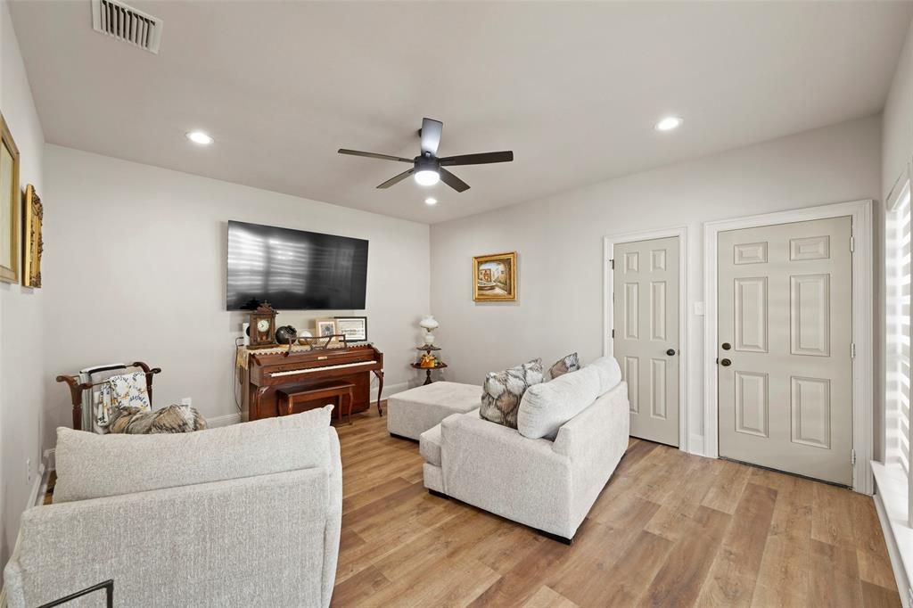 1413 Windsor Way Rowlett, TX 75088 - Photo 20 of 38 a living room with furniture and a flat screen tv