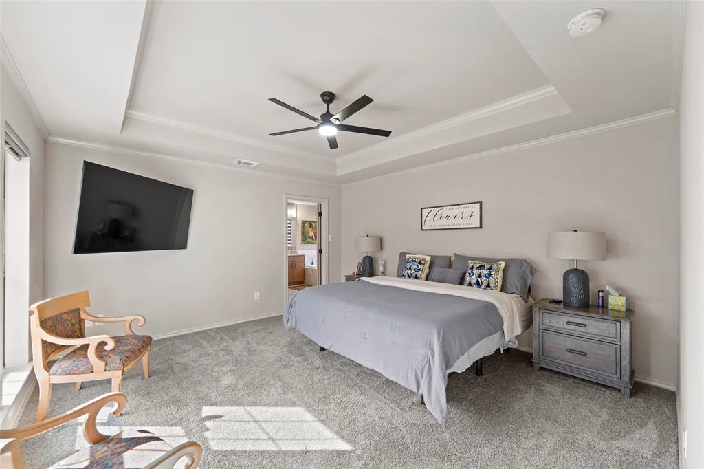 1413 Windsor Way Rowlett, TX 75088 - Photo 21 of 38 a bedroom with a bed and a table in it