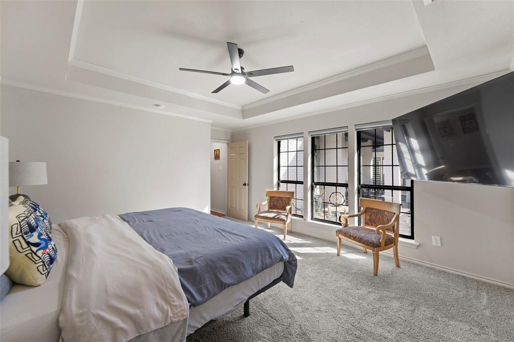 1413 Windsor Way Rowlett, TX 75088 - Photo 22 of 38 a bedroom with a bed a television and dresser