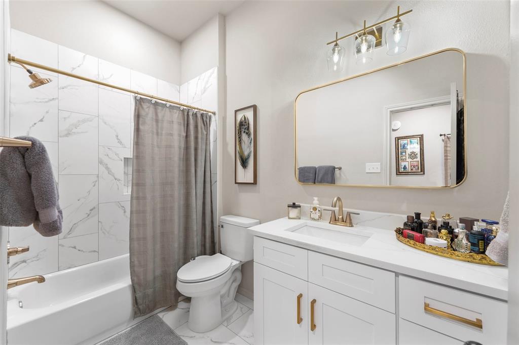 1413 Windsor Way Rowlett, TX 75088 - Photo 28 of 38 a bathroom with a sink a toilet and shower