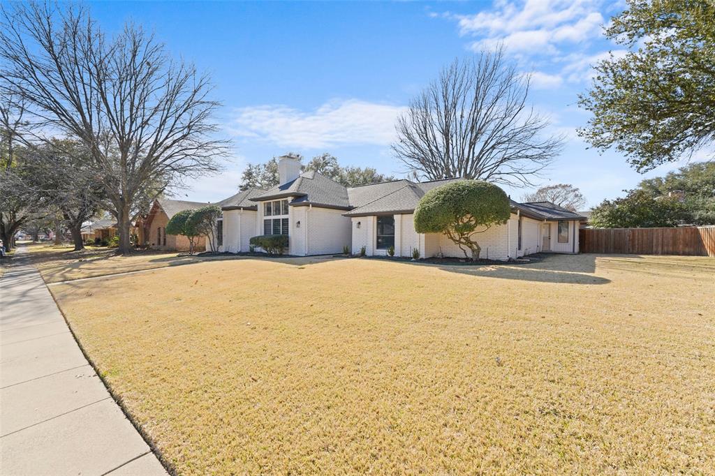 1413 Windsor Way Rowlett, TX 75088 - Photo 4 of 38 a house with a large tree with yard