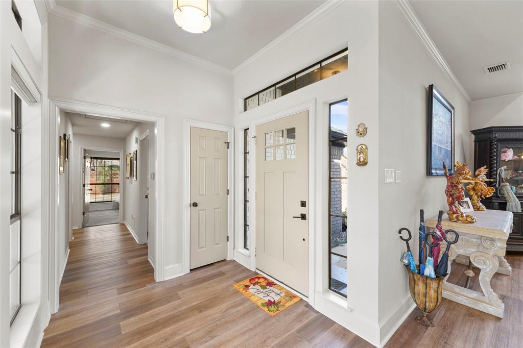 1413 Windsor Way Rowlett, TX 75088 - Photo 9 of 38 a view of a hallway with wooden floor and a living room