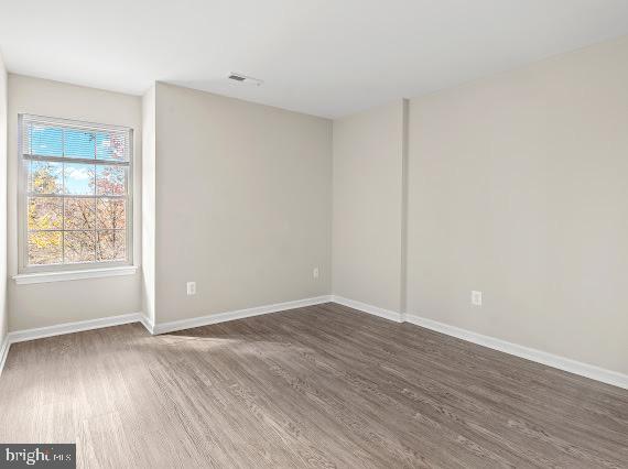203 Star Pointe Court, Unit 2C Abingdon, MD 21009 - Photo 16 of 29 an empty room with wooden floor and windows