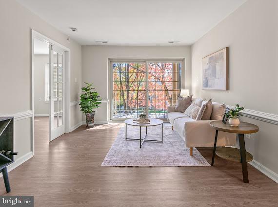 203 Star Pointe Court, Unit 2C Abingdon, MD 21009 - Photo 25 of 29 a living room with furniture a flat screen tv and a large window