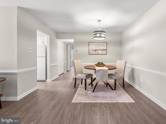 203 Star Pointe Court, Unit 2C Abingdon, MD 21009 - Photo 6 of 29 a view of a dining room with furniture wooden floor and a chandelier