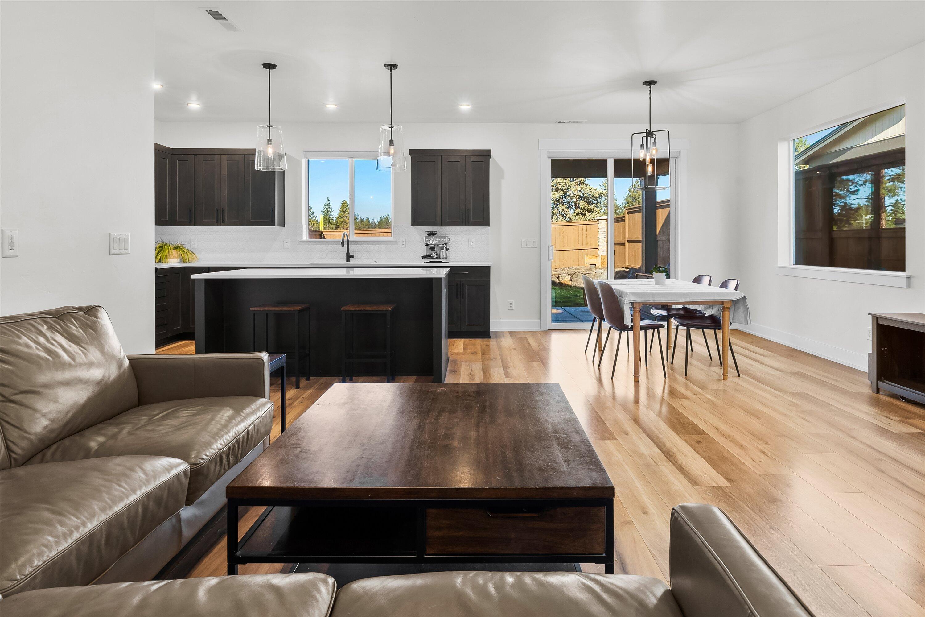 60903 Southeast Epic Place Bend, OR 97702 - Photo 11 of 48 a living room with kitchen island furniture and a wooden floor