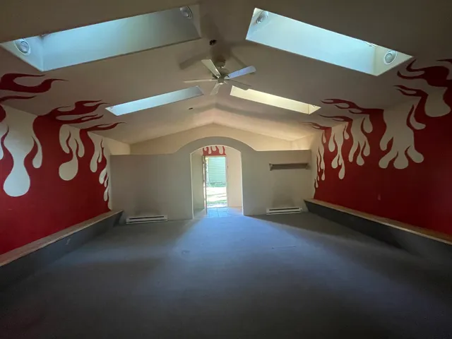 a view of empty room with ceiling fan