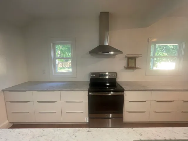 a en suite bathroom with a granite countertop sink