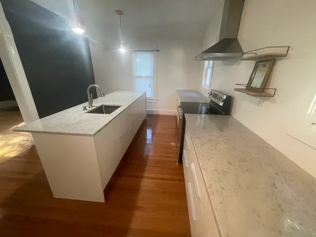 a metallic refrigerator freezer sitting in a kitchen