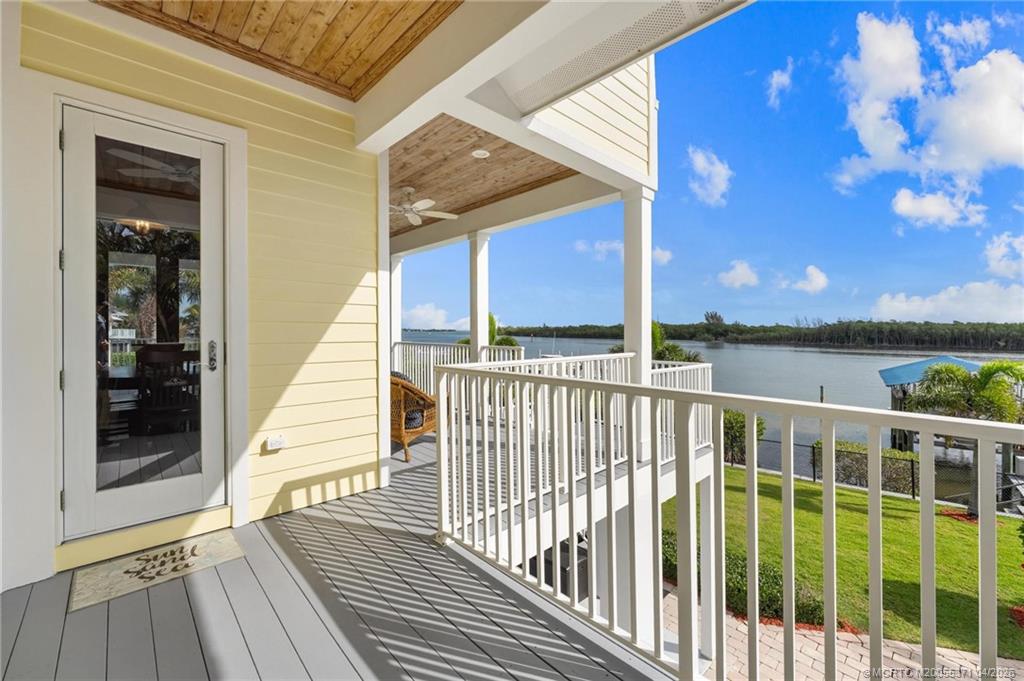5675 Southeast Orange Street Stuart, FL 34997 - Photo 17 of 96 a view of a balcony with wooden floor and fence