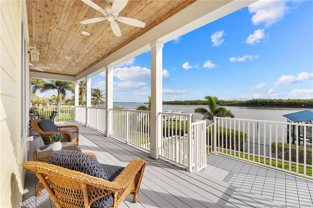 5675 Southeast Orange Street Stuart, FL 34997 - Photo 18 of 96 a view of balcony with couch and wooden floor