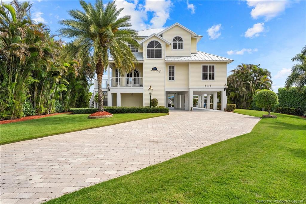 5675 Southeast Orange Street Stuart, FL 34997 - Photo 2 of 96 a view of house with outdoor space and swimming pool