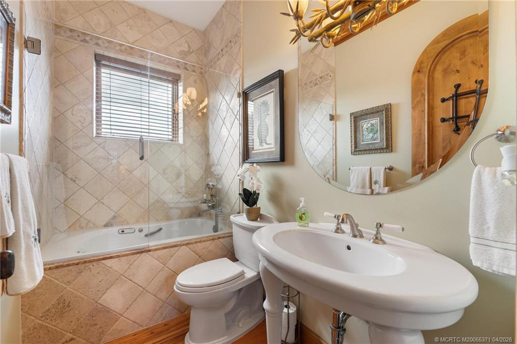 5675 Southeast Orange Street Stuart, FL 34997 - Photo 24 of 96 a bathroom with a sink toilet and shower