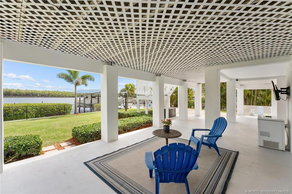 5675 Southeast Orange Street Stuart, FL 34997 - Photo 33 of 96 a view of a patio with couches chairs dining table and chairs