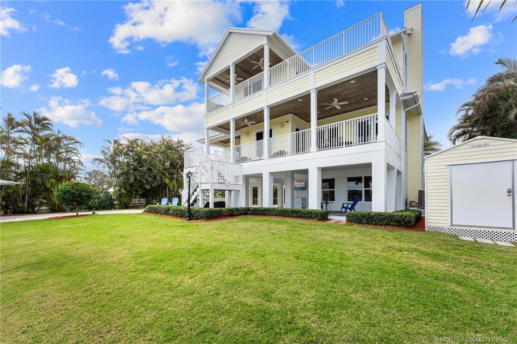 5675 Southeast Orange Street Stuart, FL 34997 - Photo 41 of 96 a view of a building with a yard