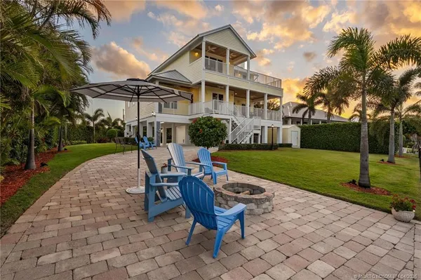 a view of a patio with couches chairs and a table with wooden floor