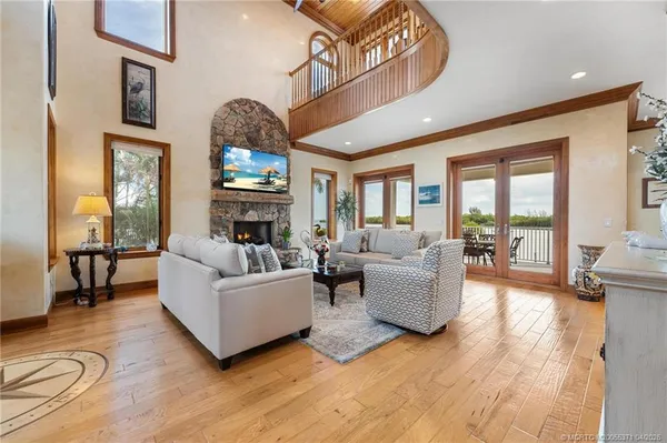 a living room with furniture a fireplace and a large window