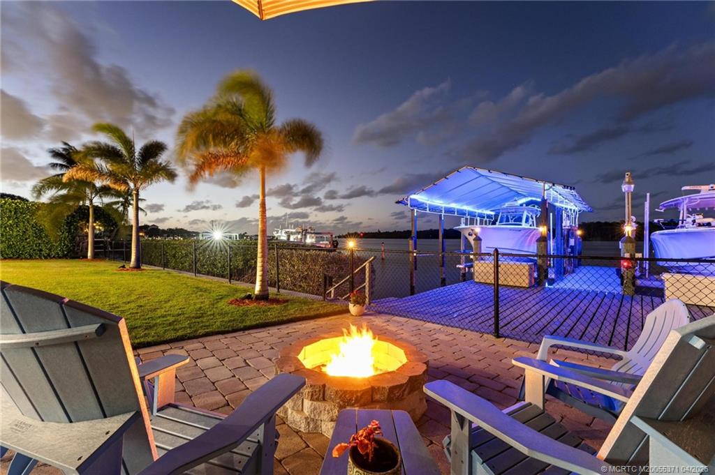 5675 Southeast Orange Street Stuart, FL 34997 - Photo 58 of 96 a view of a patio with couches table and chairs potted plants