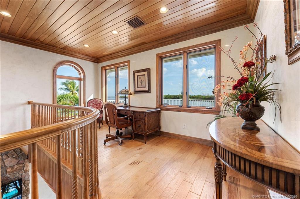 5675 Southeast Orange Street Stuart, FL 34997 - Photo 62 of 96 a balcony with furniture and potted plants