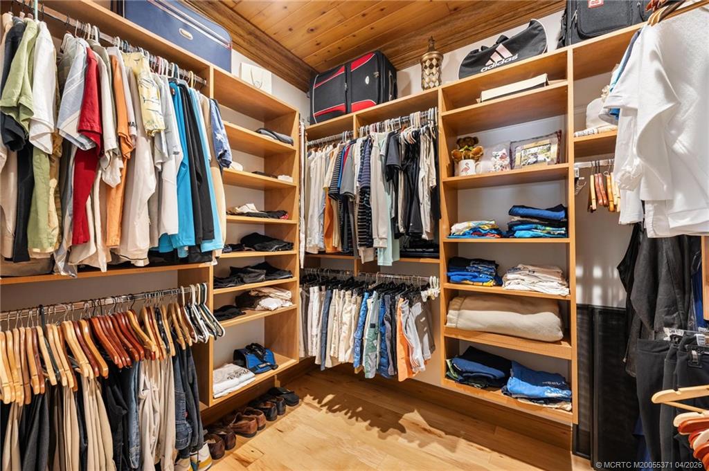 5675 Southeast Orange Street Stuart, FL 34997 - Photo 70 of 96 a view of walk in closet with clothes and shoes