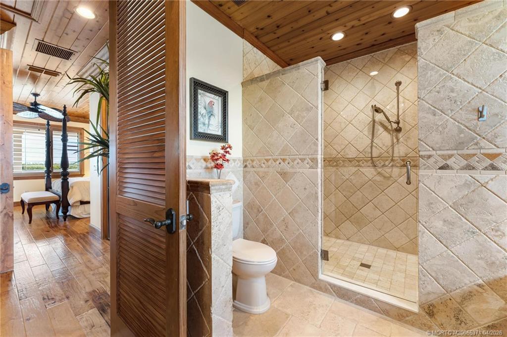 5675 Southeast Orange Street Stuart, FL 34997 - Photo 74 of 96 a bathroom with a shower and a toilet