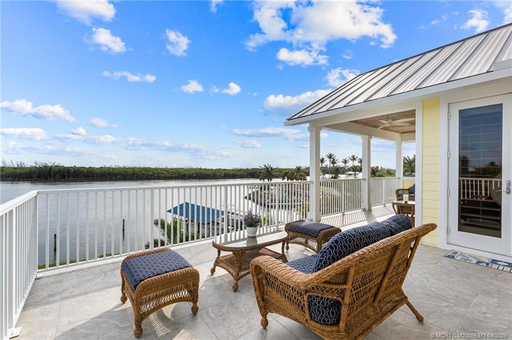5675 Southeast Orange Street Stuart, FL 34997 - Photo 78 of 96 a view of a patio with couches chairs and a table with wooden floor
