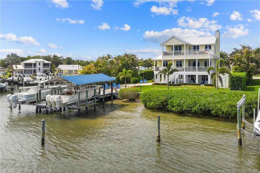 5675 Southeast Orange Street Stuart, FL 34997 - Photo 89 of 96 a view of a lake with a building in the background
