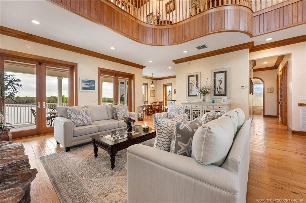 5675 Southeast Orange Street Stuart, FL 34997 - Photo 10 of 96 a living room with furniture a couch and a chandelier