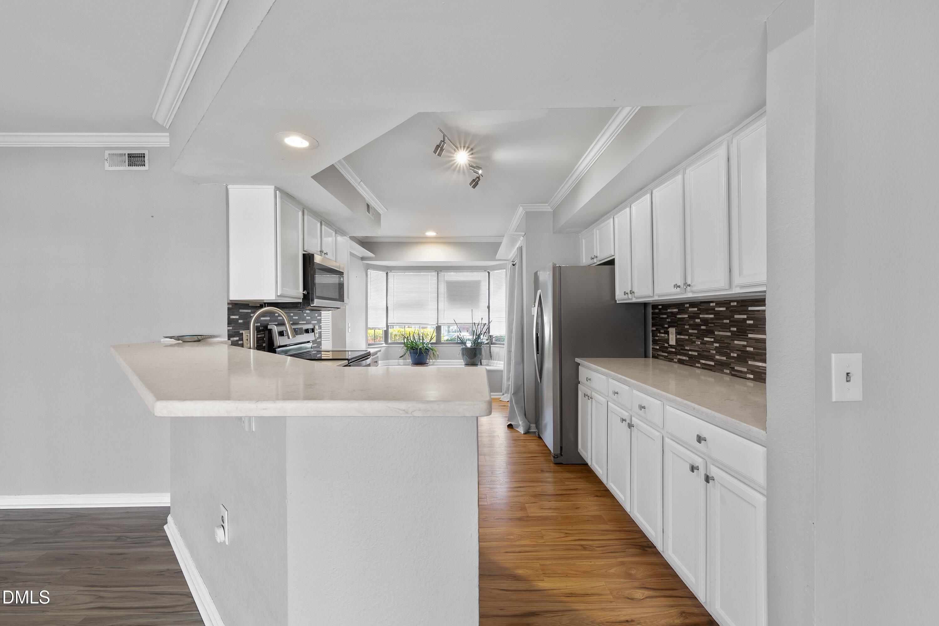 2400 Condor Court Raleigh, NC 27615 - Photo 15 of 40 a large white kitchen with a sink and dishwasher