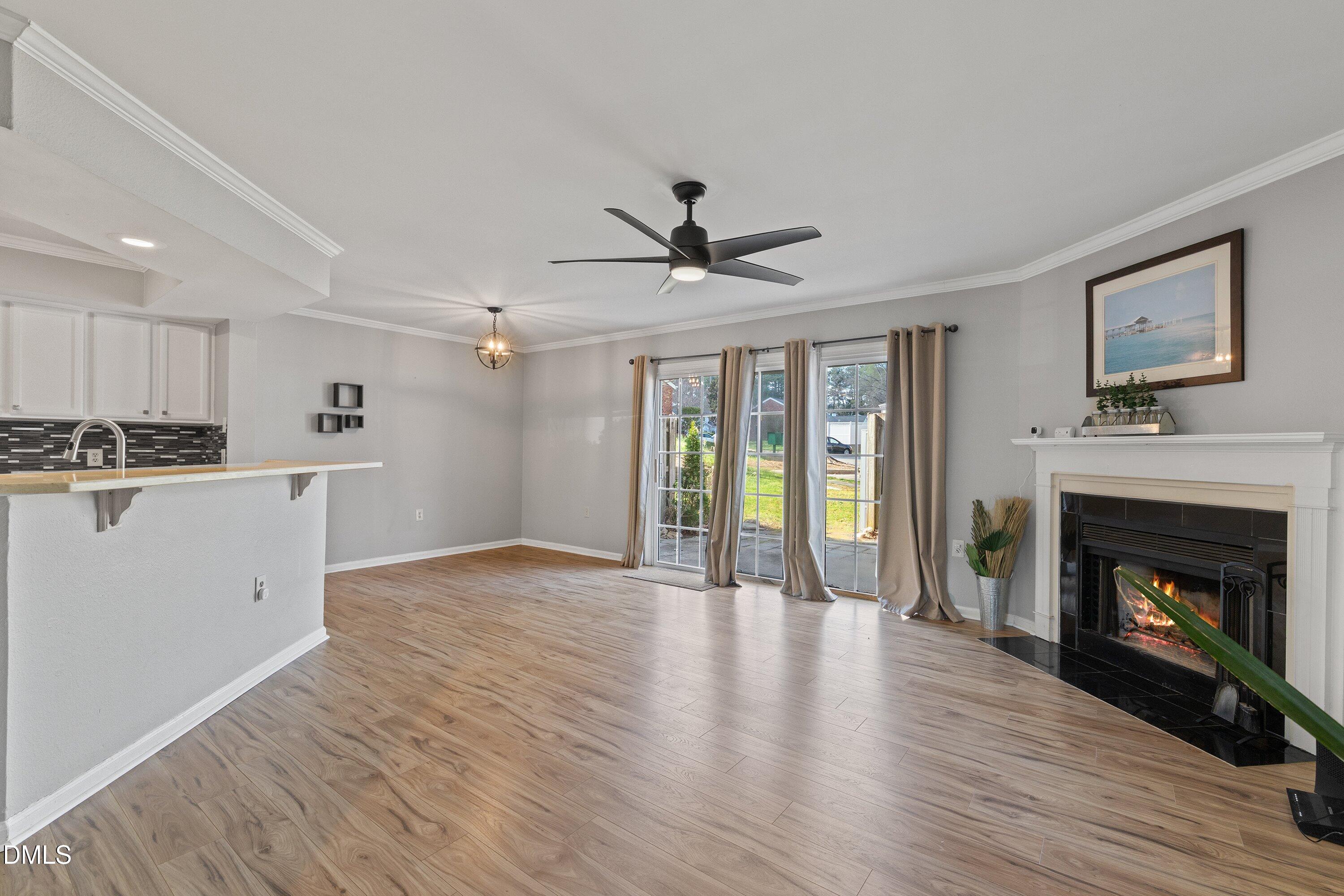 2400 Condor Court Raleigh, NC 27615 - Photo 23 of 40 a view of an empty room with a fireplace and a window