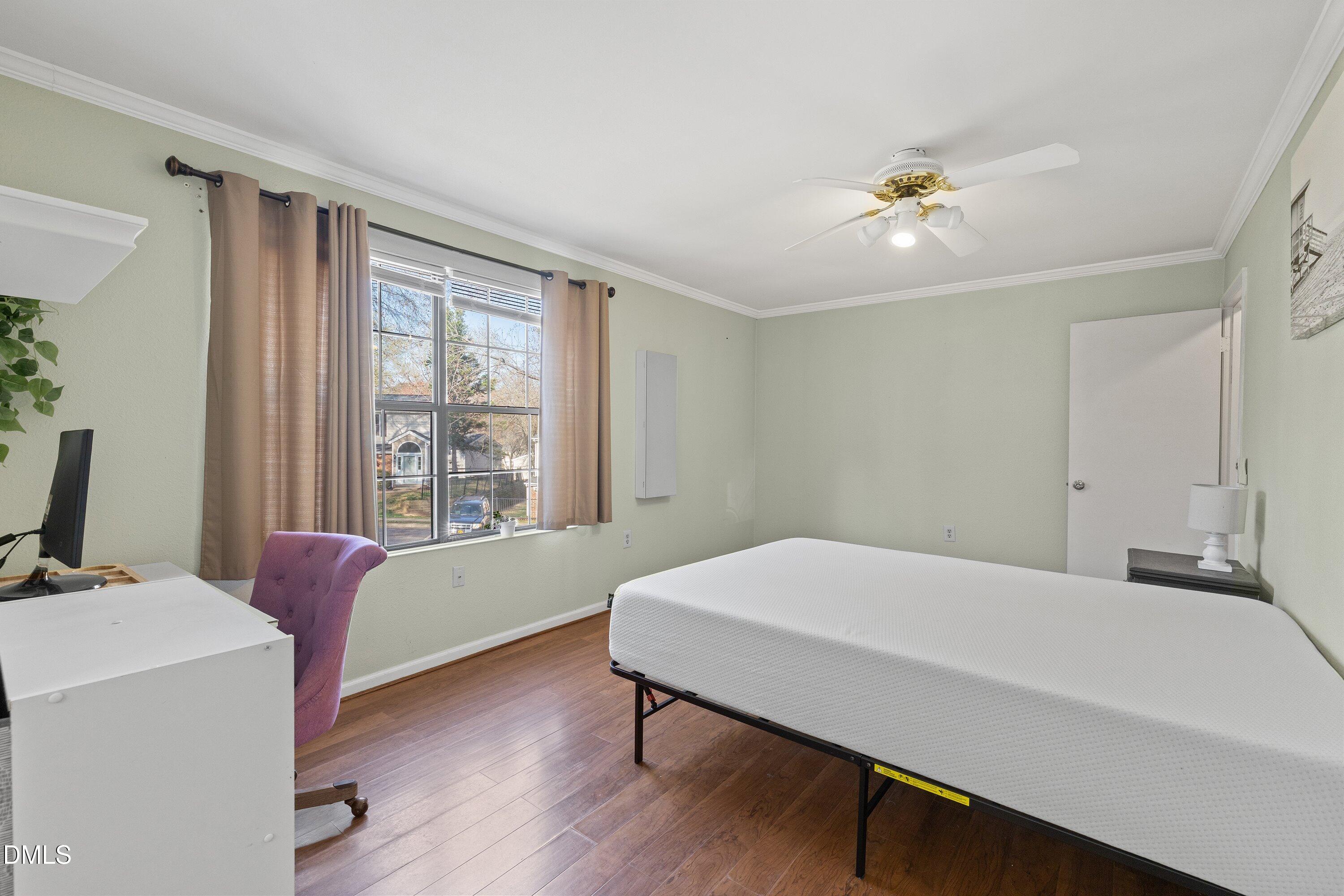 2400 Condor Court Raleigh, NC 27615 - Photo 26 of 40 a bedroom with a bed and a chandelier