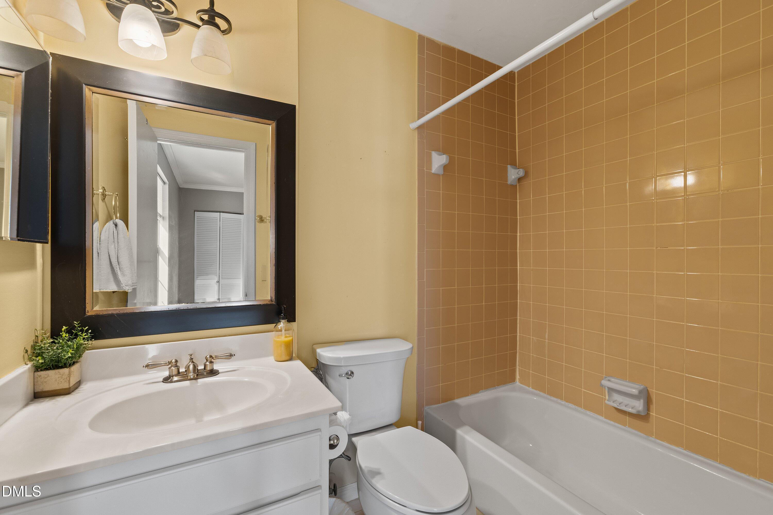 2400 Condor Court Raleigh, NC 27615 - Photo 33 of 40 a bathroom with a sink a toilet and shower