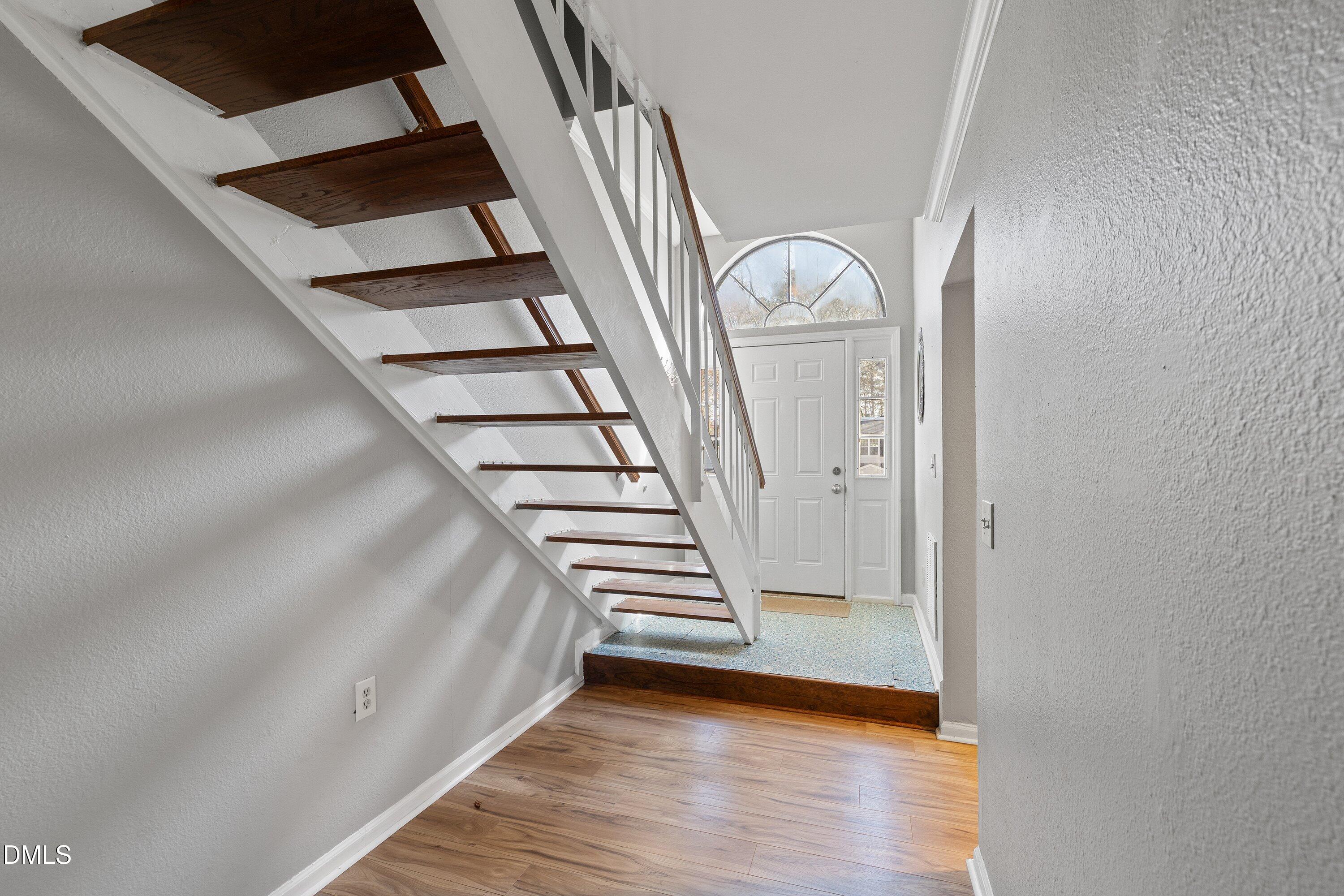 2400 Condor Court Raleigh, NC 27615 - Photo 5 of 40 a view of a livingroom with wooden floor and stairs