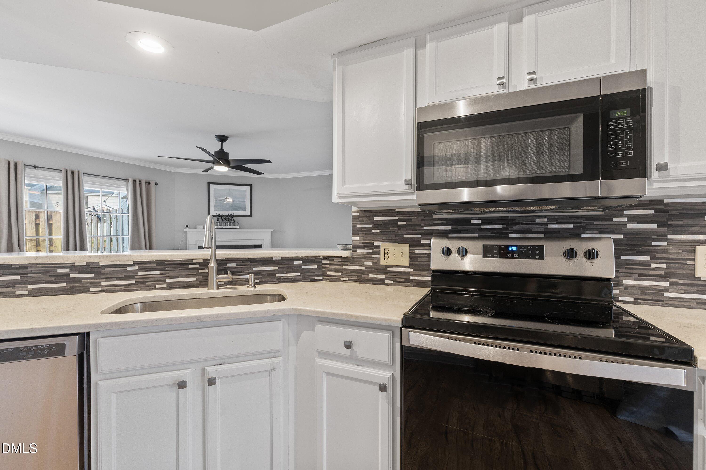 2400 Condor Court Raleigh, NC 27615 - Photo 10 of 40 a kitchen with a stove and a microwave