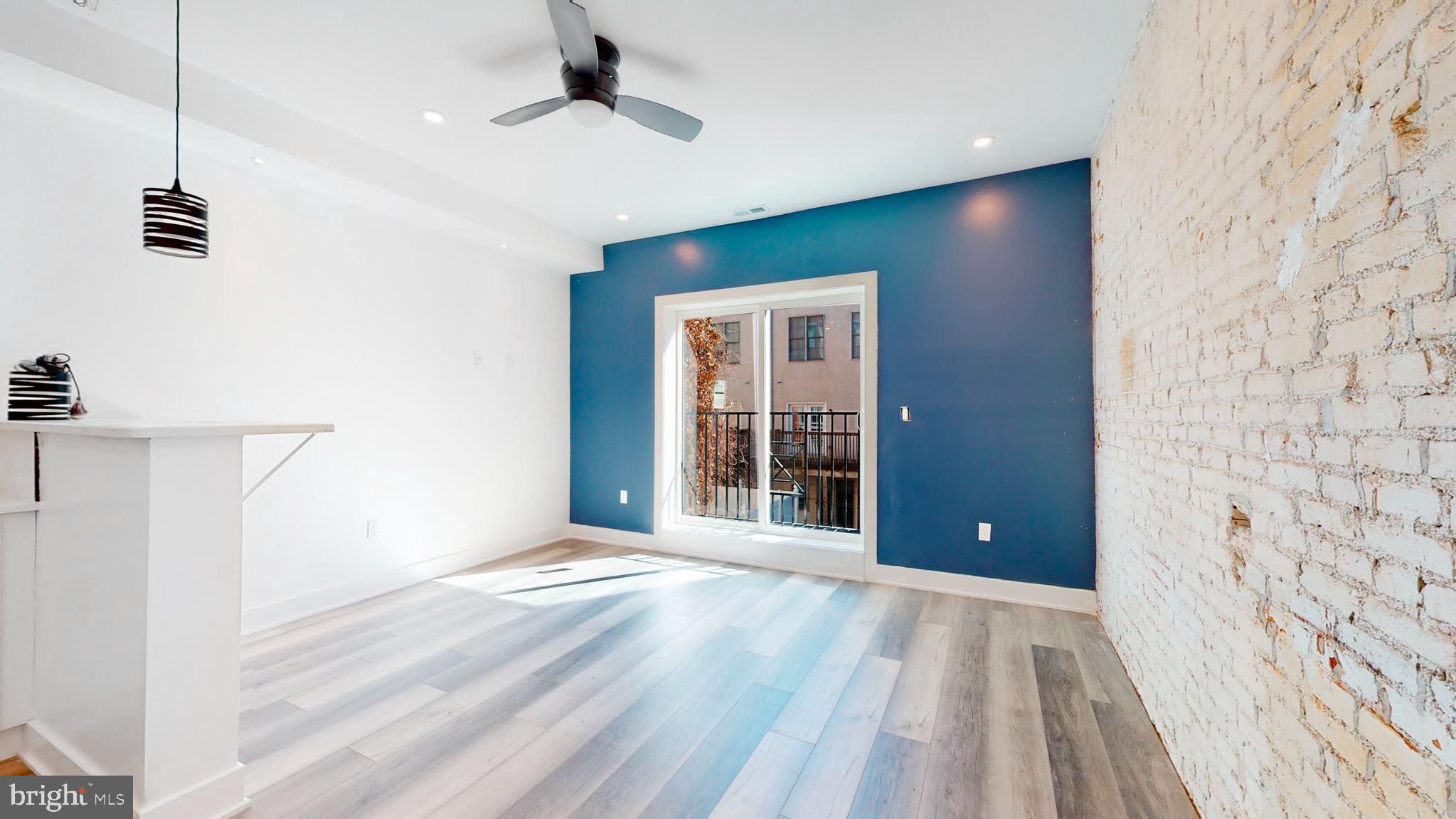 651 North 16th Street, Unit 2 Philadelphia, PA 19130 - Photo 3 of 19 wooden floor in an empty room with a window