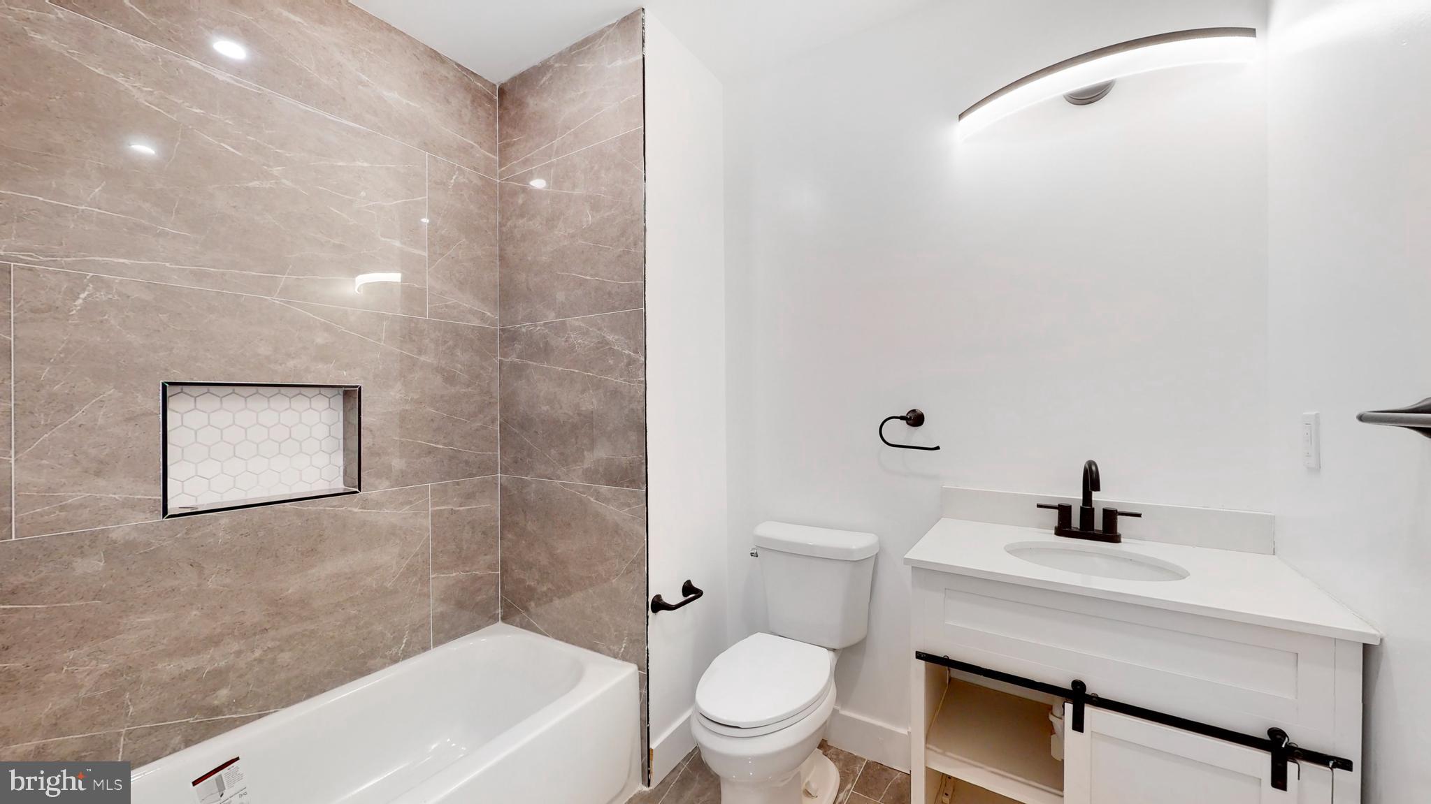 651 North 16th Street, Unit 2 Philadelphia, PA 19130 - Photo 10 of 19 a bathroom with a sink a toilet and shower