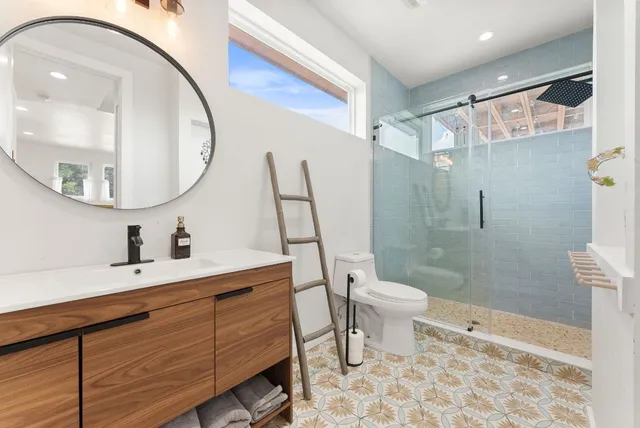 a spacious bathroom with a toilet sink and mirror